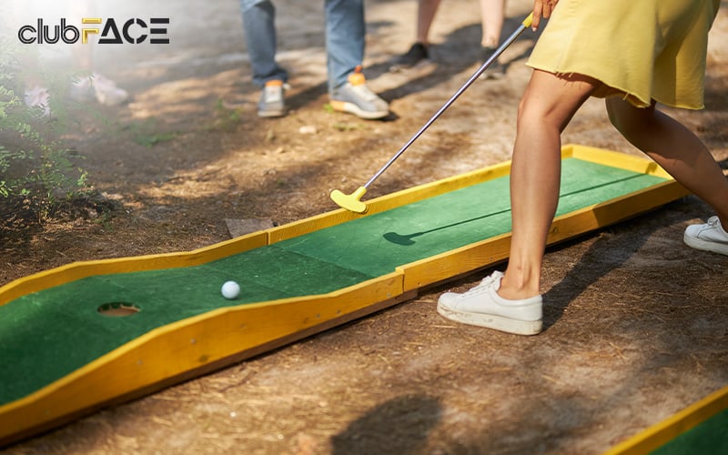 family playing mini golf