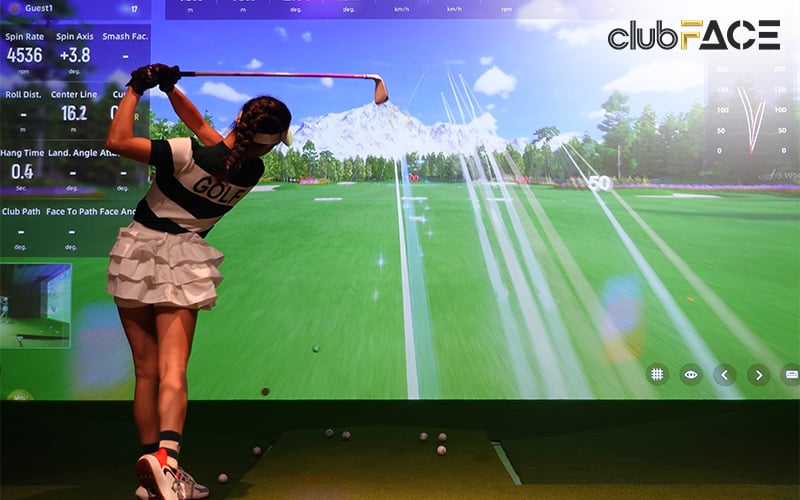 A woman engaged in indoor golf simulation