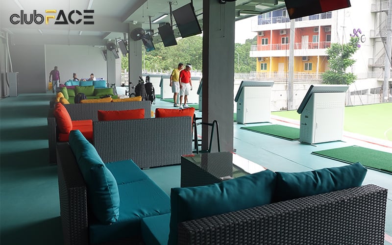 Clean and organised golf bays with lounge seating after use