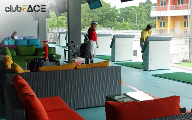Golfers practicing at an indoor golf facility at clubFACE