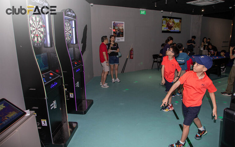 Kids throwing darts at a birthday party held at clubFACE