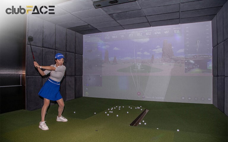 Woman playing a golf simulator